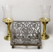 A pair of brass candlesticks with spring loading actions and storm shades and a Victorian cast brass