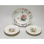 A Meissen plate with crown and fish crest boldly painted with flowers, crossed swords in blue, and