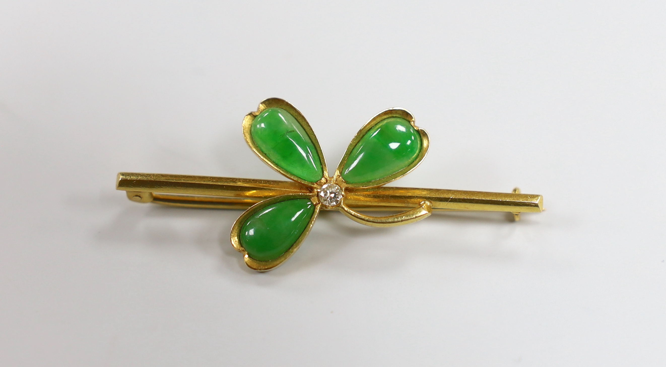 A Chinese yellow metal jade and diamond set petal bar brooch, 47mm, gross weight 4.9 grams, in