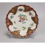 A Worcester small plate painted with fruit and flowers under a crimson and floral gilt border, 17.