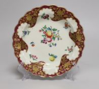 A Worcester small plate painted with fruit and flowers under a crimson and floral gilt border, 17.