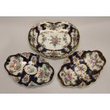 A pair of Worcester oval lobed dishes painted with flowers on a blue scale ground and a matching