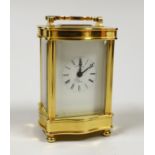 A French miniature brass cased serpentine fronted eight day carriage timepiece by L’Epee, 9cm high