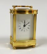 A French miniature brass cased serpentine fronted eight day carriage timepiece by L’Epee, 9cm high