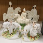 A pair of Staffordshire cow herder figure groups and three Staffordshire equestrian groups,