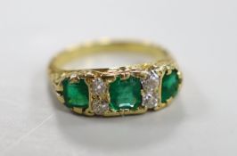 A yellow metal and three stone emerald half hoop ring with four stone diamond set spacers, size M/N,