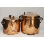 Two Victorian copper lidded vessels, with wrought iron swing handles, largest 25 cm high with the
