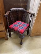 A Victorian carved oak corner elbow chair, width 67cm, depth 62cm, height 80cm