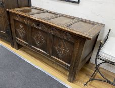 A late 17th century oak coffer, with a panelled top and lozenge carved front, length 128cm, depth