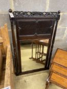 An early 20th century Jacobean revival oak wall mirror, width 70cm, height 117cm