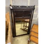 An early 20th century Jacobean revival oak wall mirror, width 70cm, height 117cm