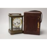 A large 19th century carriage clock with enamel dial and velvet lined leather case, the clock 19cm