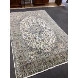 A Kashan ivory ground carpet, 300 x 195cm
