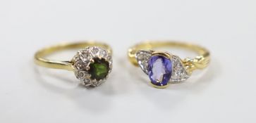 A modern 18ct gold and single stone oval cut tanzanite and diamond chip set cluster dress ring, size