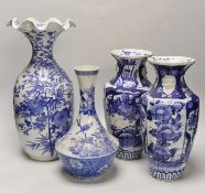 A pair of Japanese blue and white birds and flowers pattern vases and two other vases, tallest