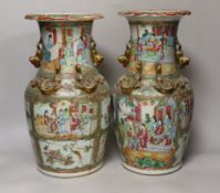 A pair of Chinese Canton decorated famille rose enamelled vases, 36cm high