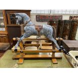 A G&J Lines type rocking horse on beech safety frame (later painted), length 112cm, height 97cm