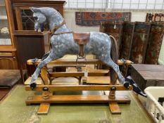 A G&J Lines type rocking horse on beech safety frame (later painted), length 112cm, height 97cm
