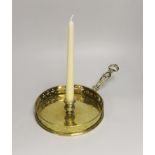 A brass chamberstick, with a wide drip pan and pierced galleried border, 32cm wide