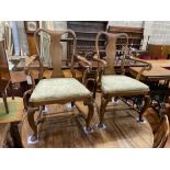 A set of four George I walnut dining chairs and two later matching elbow chairs with upholstered