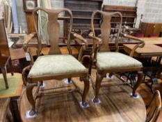 A set of four George I walnut dining chairs and two later matching elbow chairs with upholstered