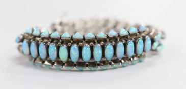 A large sterling and man made opal cluster set curb and arch link bracelet, gross weight 85.8