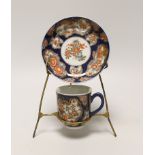 A Samson replica of a Worcester scale blue cup and saucer, hand painted with flowers on stand, the