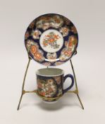 A Samson replica of a Worcester scale blue cup and saucer, hand painted with flowers on stand, the