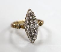An early 20th century 18ct and diamond cluster set marquise shaped ring (one stone replaced), size