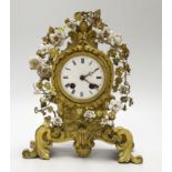 A 19th century gilt bronze and porcelain mounted mantel clock, the waisted case cast with