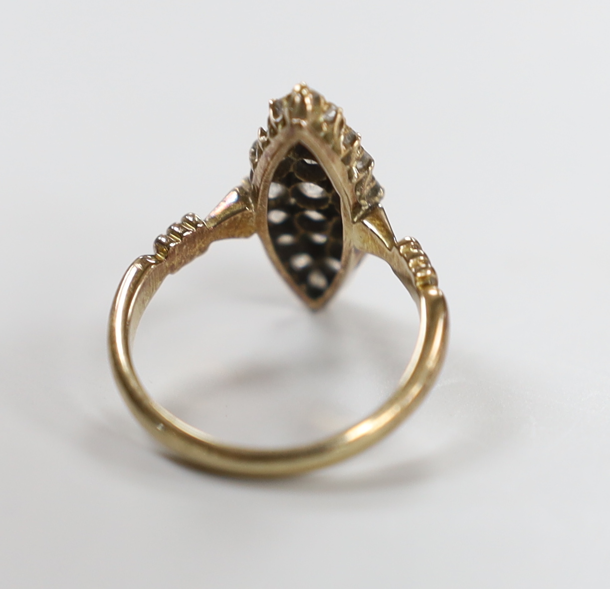 An early 20th century 18ct and diamond cluster set marquise shaped ring (one stone replaced), size - Image 3 of 3