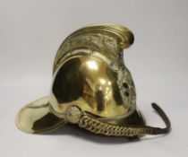A late 19th/early 20th century brass Merryweather fire brigade helmet with embossed decoration and