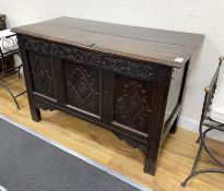 A late 17th century oak coffer the front carved with three lozenge medallion panels, length 115cm,