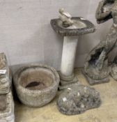 A reconstituted stone bird bath with a figure of a bird, height 70cm, a circular planter and a