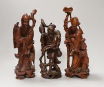 Three Chinese carved wood figures of Shou Lao and a fisherman, the largest 25cm high