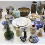 A collection of studio pottery including a Kenneth Annat Bemersyde Scottish vase, two graduated
