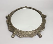 An electroplate mirrored plateau or cake stand decorated with lions and swags, 36cm in diameter