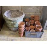 Approximately 45 assorted small terracotta pots and a circular reconstituted stone planter, diameter