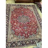 A North West Persian red ground floral carpet, 320 x 234cm