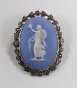 A white metal mounted Wedgwood blue jasper oval brooch, decorated with the figure of a maiden,