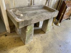 A rectangular carved stone trough on four tapered stone pillars, width 120cm, depth 59cm, height