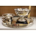 A plated galleried oval tray, an Arts & Crafts style punch bowl and bottle coaster, tray 60cm wide