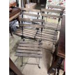 A set of four wrought iron slatted wood folding garden chairs