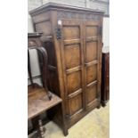 An 18th century style panelled oak hanging cupboard, width 96cm, depth 53cm, height 178cm