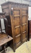 An 18th century style panelled oak hanging cupboard, width 96cm, depth 53cm, height 178cm