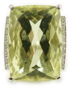 A modern white gold and shaped rectangular fancy cut pale green beryl set dress ring, with diamond