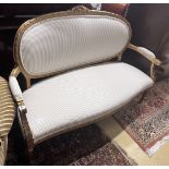 A French giltwood and composition settee, recently re-upholstered in a striped linen fabric, width