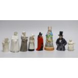 A collection of eight extinguishers including Worcester and Royal Doulton, the largest 13cm high