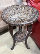 A Japanese circular carved wood two tier occasional table, diameter 40cm, height 70cm