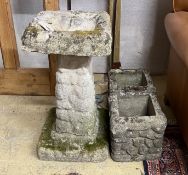 A pebble effect reconstituted stone bird bath, height 67cm together with two similar smaller